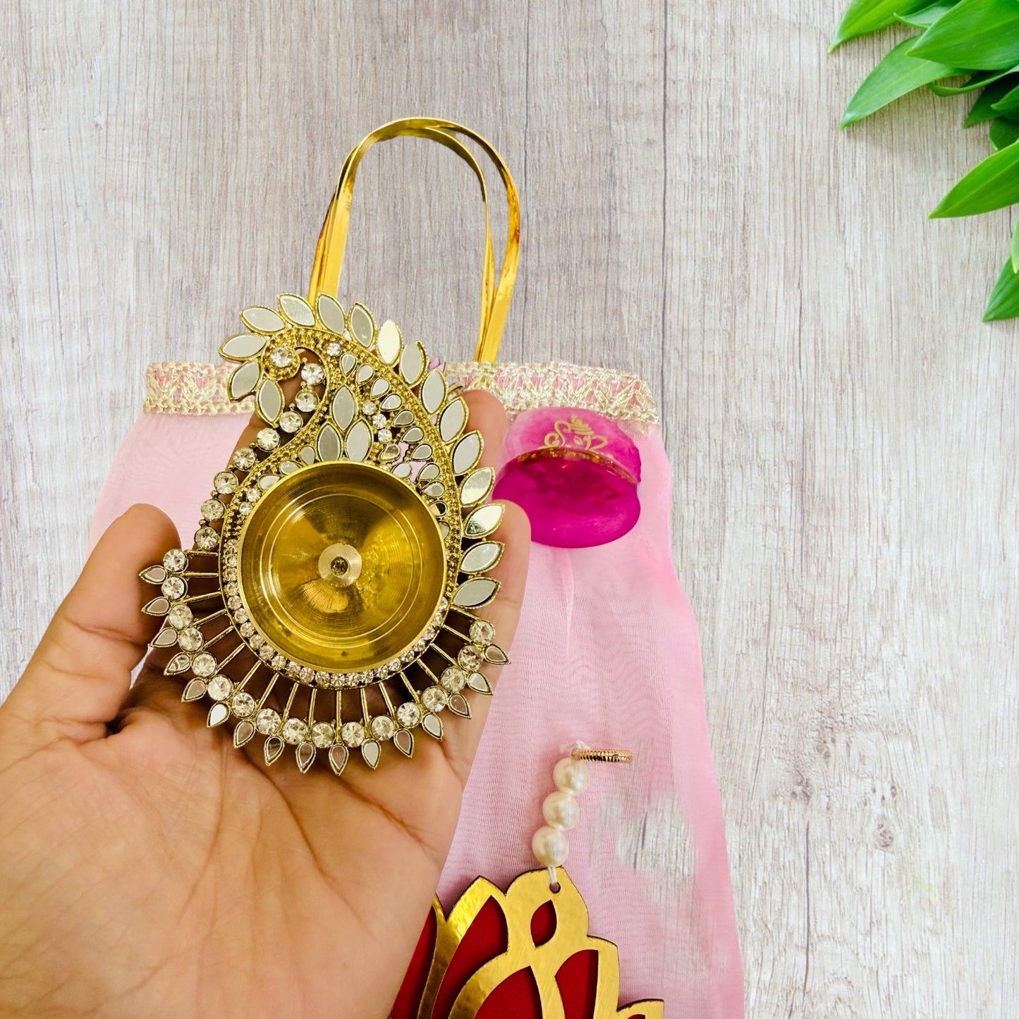 Combo of Akhand Diya, Resin Ganesha, Lotus Hanging in Organza Bag