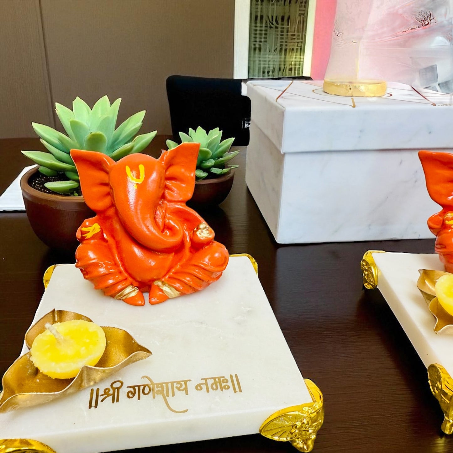 Orange Ganesha on Marble Chowki