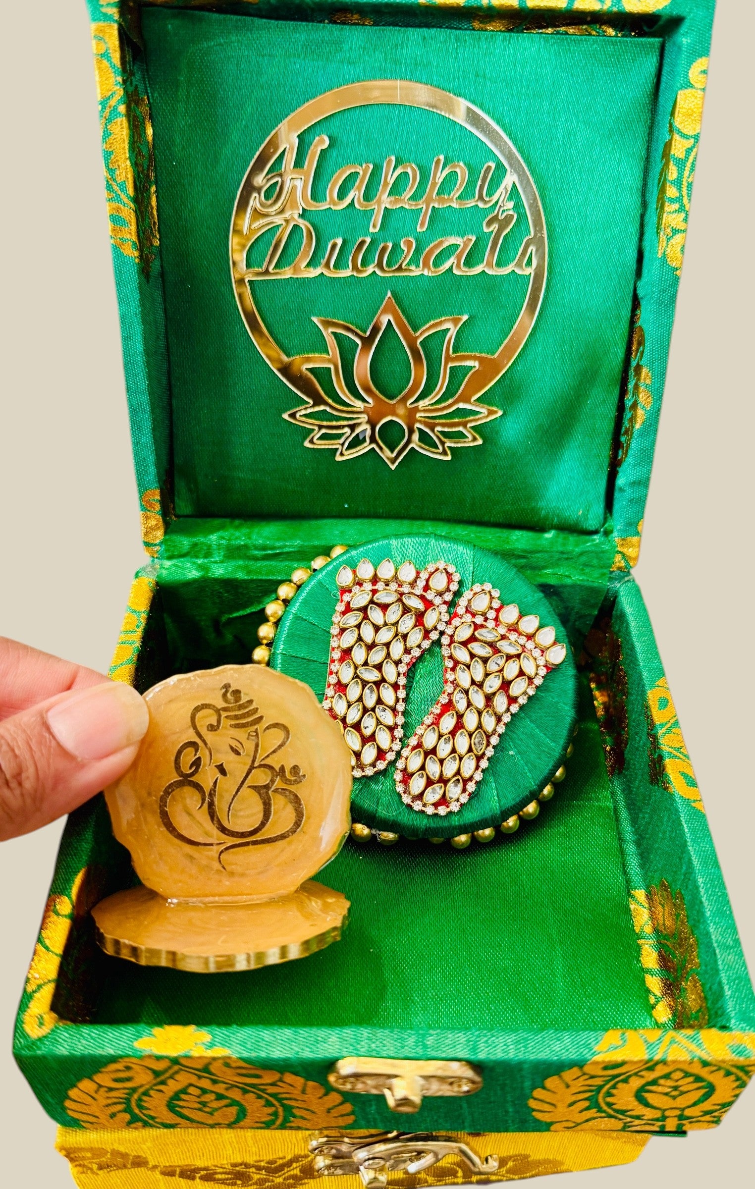 Decorative items with 'Happy Diwali' design in a green box.