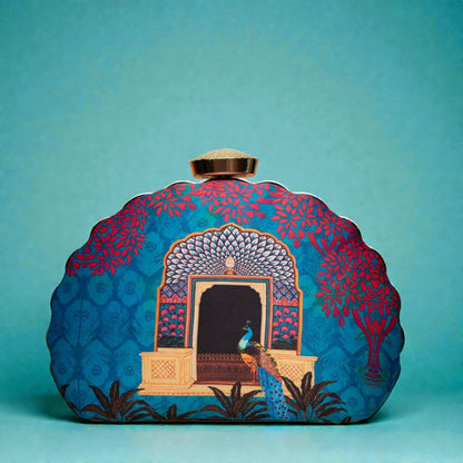 Designer Clutch with Peacock Standing in Front of an Ornate Arched Doorway