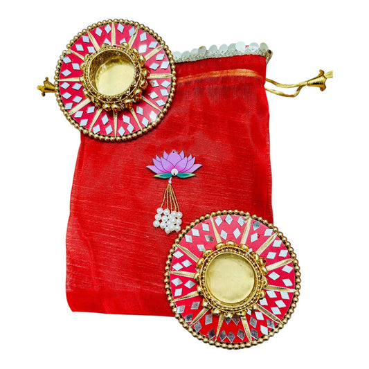 Decorative red pouch with gold and pink embellishments on a white background
