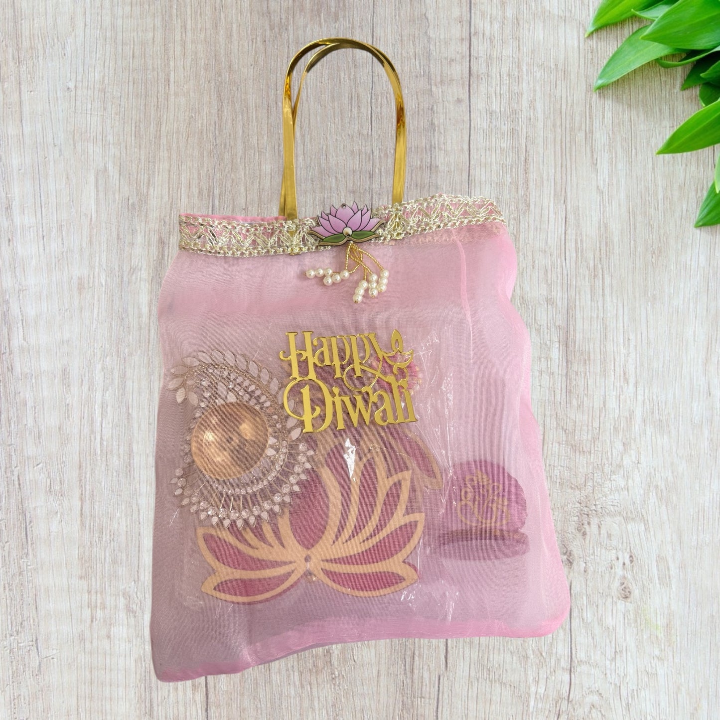 Combo of Akhand Diya, Resin Ganesha, Lotus Hanging in Organza Bag
